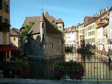Annecy Flower Bedecked Bridge With View Of The Île Palace Former