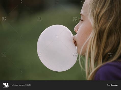 Little Girl Blowing A Bubble With Chewing Gum Stock Photo Offset