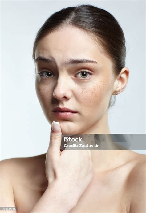 headshot of emotional female face portrait with unhappy misunderstanding facial expression stock