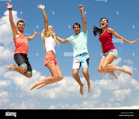 Portrait Of Four Jumping Happy People Stock Photo Alamy
