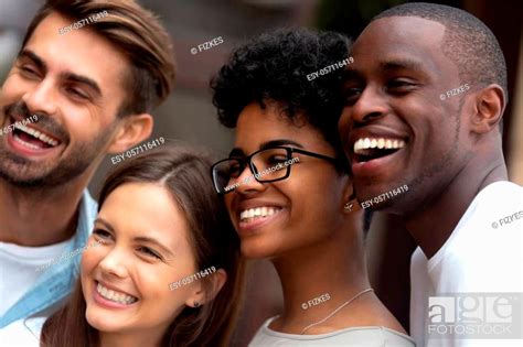Close Up Portrait Of Smiling Multiracial Millennial Friends Laugh Stand Posing For Group Picture
