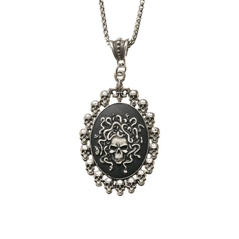 antiqued white medusa cameo in skull frame pendant