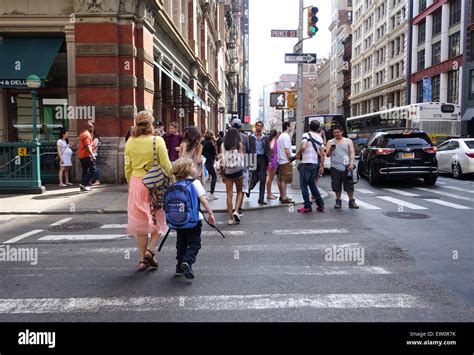 Mother And Child Crossing Street In New York City Street Life