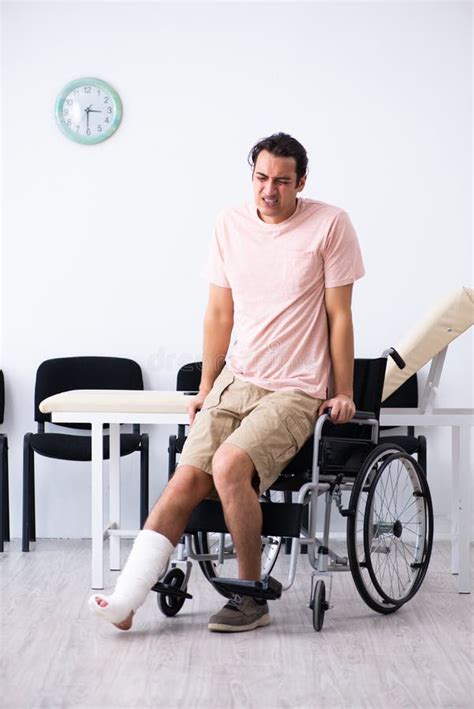 Young Injured Man Waiting For His Turn In Hospital Hall Stock Photo