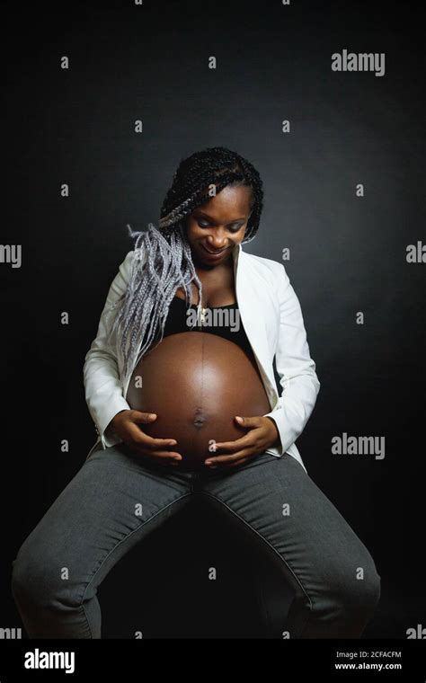 Young Pregnant African American Female With Braids Wearing White Blazer