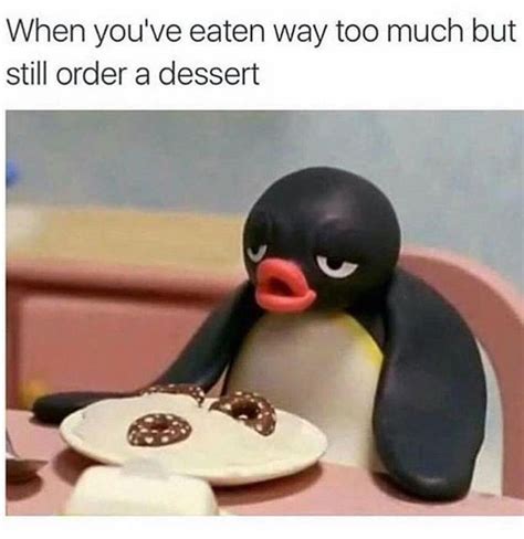 A Penguin Sitting At A Table With A Plate In Front Of It That Says