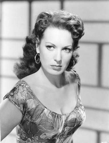 An Old Black And White Photo Of A Woman In A Dress With Large Hoop Earrings