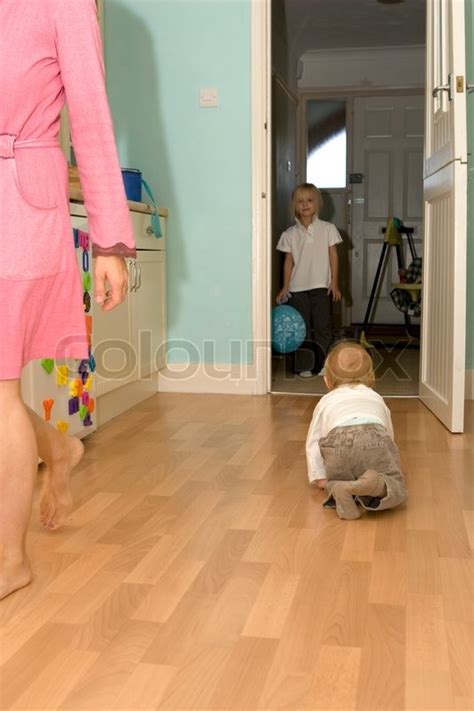 A Toddler Crawling On The Floor Stock Photo Colourbox