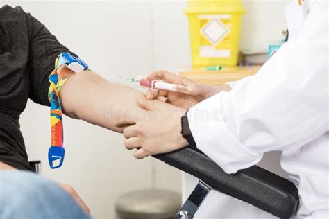 Cropped Image Of Doctor Collecting Blood From Patient Stock Photo