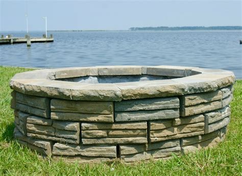 This firepit is constructed of firebrick with a concrete cap that has an old world look of weathered stone. Remodelaholic | DIY Retaining Wall Block Fire Pit