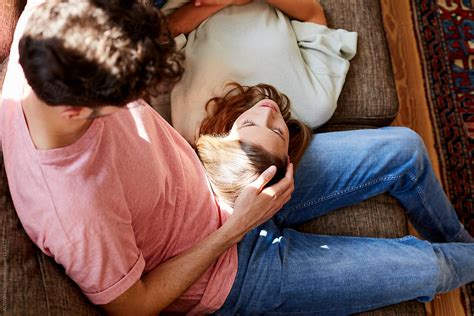 Babe Woman Resting Head On Man S Lap In Living Room Del Colaborador De Stocksy ALTO IMAGES