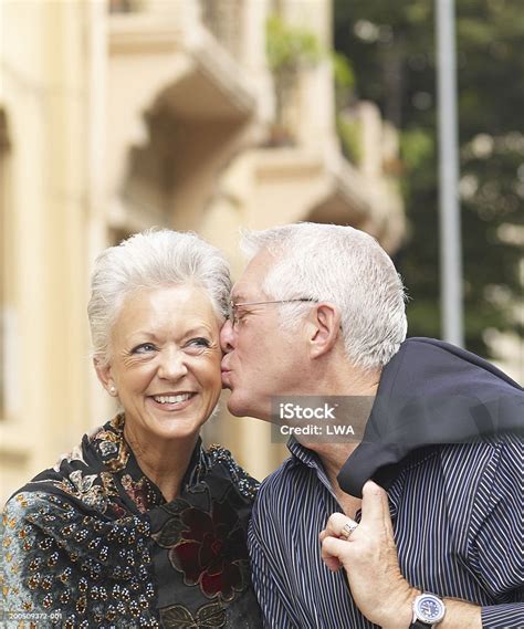 Mature Man Kissing Mature Woman Smiling Stock Photo Download Image