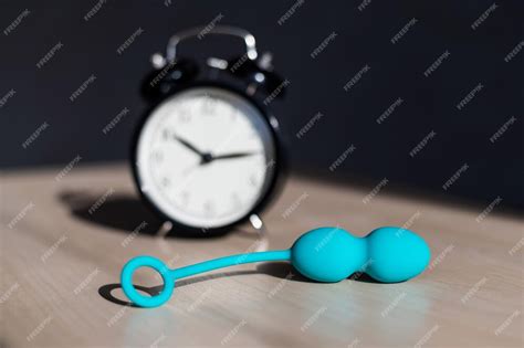 Premium Photo Alarm Clock And Vibrator On The Table Time For Training