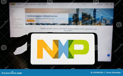 Person Holding Cellphone With Logo Of Dutch Company Nxp Semiconductors N V On Screen In Front