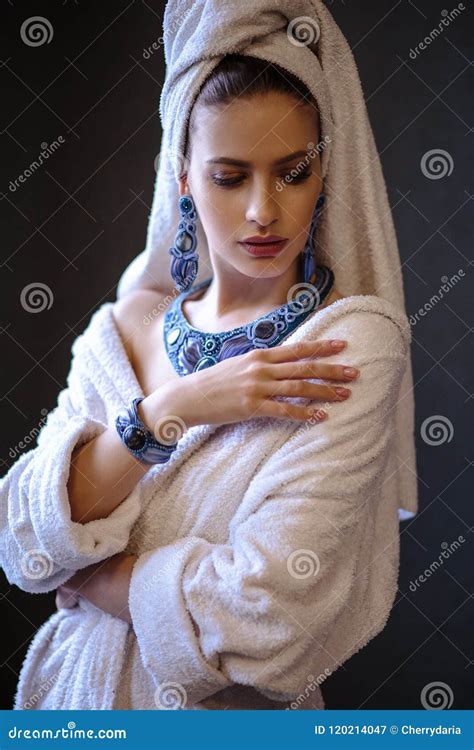 Young Woman In A Bathrobe And Towel On Her Head Fashion Jewelry Spa And Care Portrait Clean