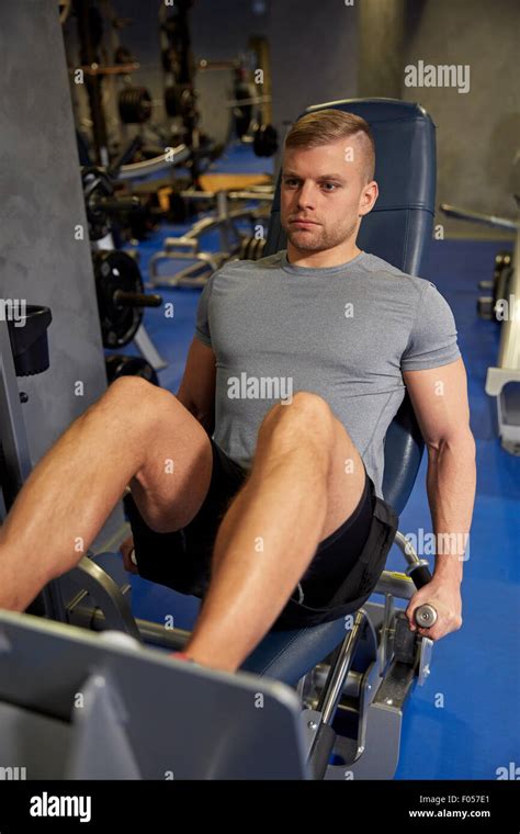Man Flexing Leg Muscles On Gym Machine Stock Photo Alamy