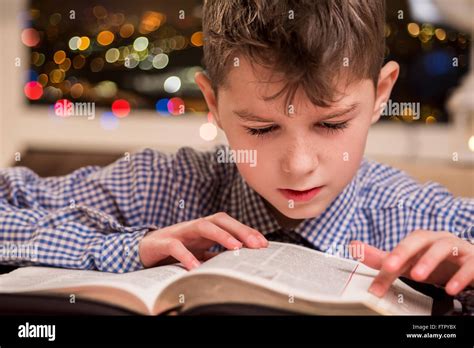 Child Reading A Thick Book Stock Photo Alamy