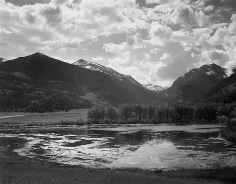 Ansel Adams Lake And Trees In Foreground Mountains And Clouds In