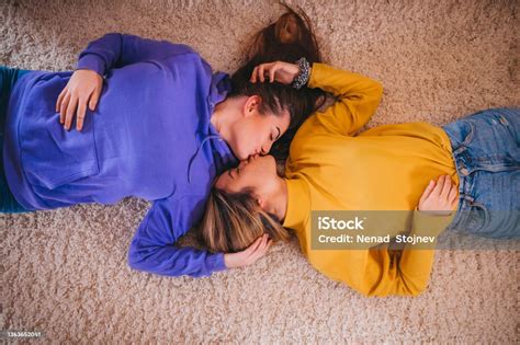 Lesbian Couple Having Fun Holding Hands And Lying On The Floor Stok