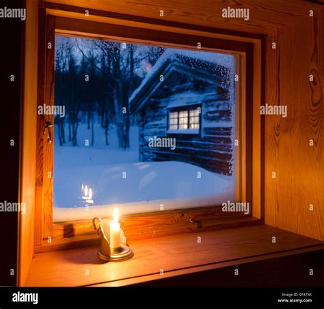 Inside Traditional Log Cabin Candle Light And Frosty Window In A