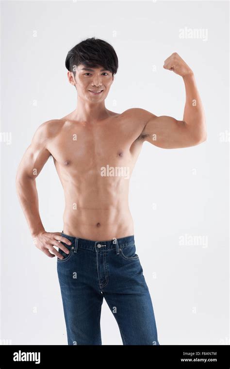 Confident Man Showing His Muscular Upper Body And Raising Arms With A