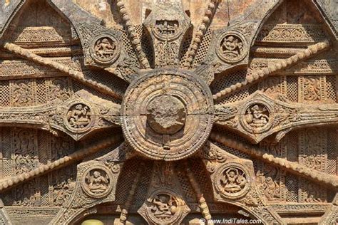 An Intricately Carved Wheel On The Side Of A Building
