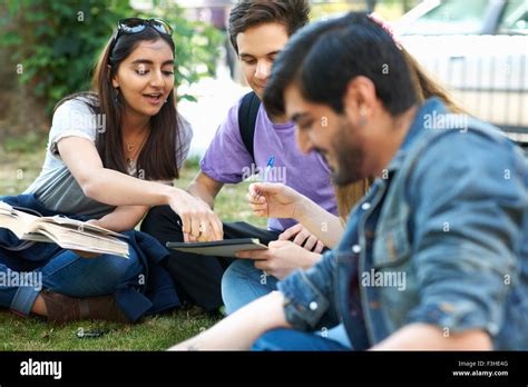 Teenage Boy And Higher Education Students On College Campus Hi Res