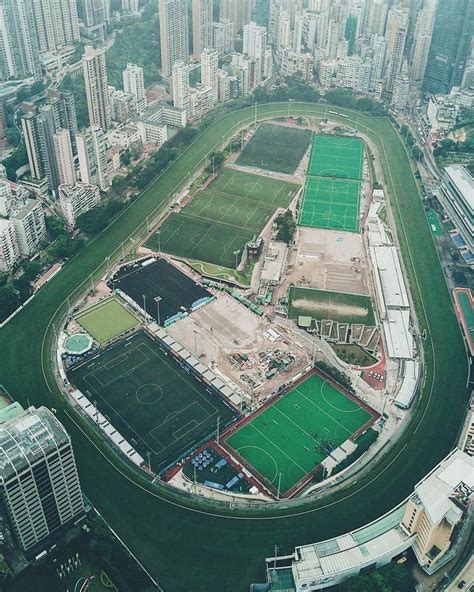 An Aerial View Of A Tennis Court In The Middle Of A City With Tall Buildings