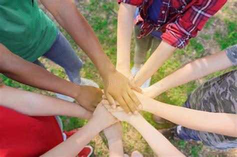 Group Of Volunteers Putting Hands Together Outdoors Stock Image Image