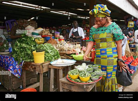 A Woman Buys Vegetables At A Market In Abuja Nigeria 02 August 2007