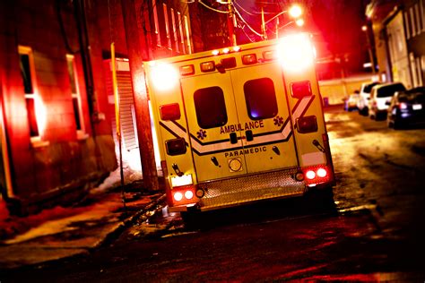 An Ambulance Car Parked On The Side Street At Night Valley Recovery