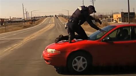 Shocking Video Shows Cop Pointing Gun As He Clings To Hood Of Speeding
