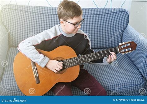 Learning To Play The Guitar Music Education Boy Playing Acoustic