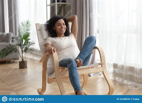 Happy Biracial Woman Relax In Rocking Chair At Home Stock Image Image
