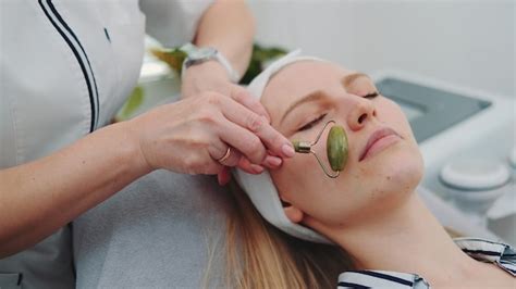 Premium Photo Close Up Shot Of Facial Massage With A Jade Roller On Womans Face At Beauty Salon