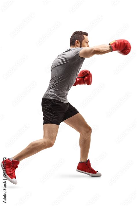 Young Guy Punching With Boxing Gloves Stock Photo Adobe Stock