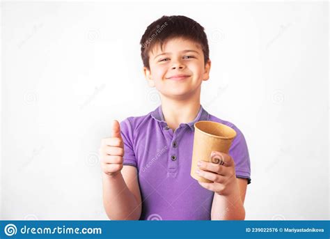 Smiling Boy Holds A Plastic And A Paper Drinking Cup In The Hands