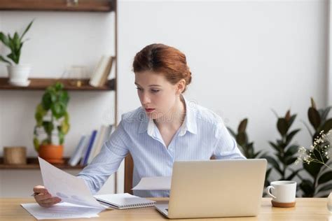 Concentrated Serious Young Woman Working With Business Document And