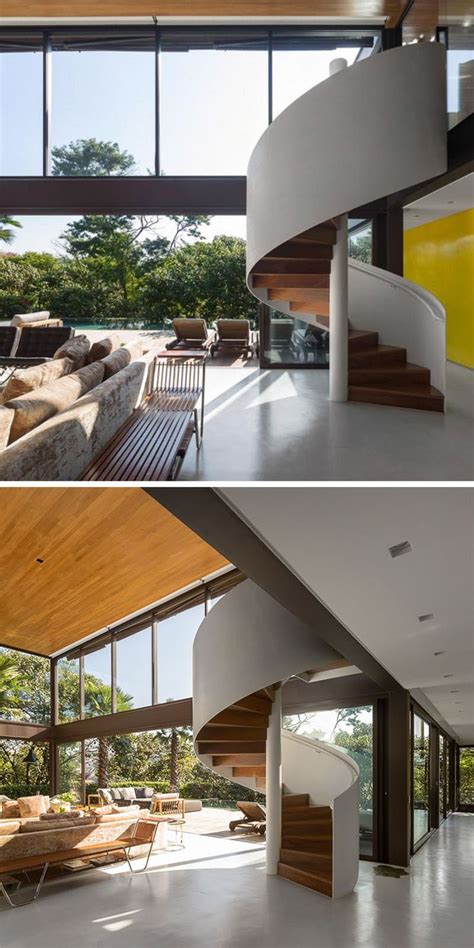 This Modern House Has A Spiral Staircase Leading Up To The Second Floor