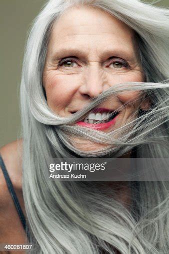 Mature Woman With Hair Blown Across Face Smiling Photo Getty Images