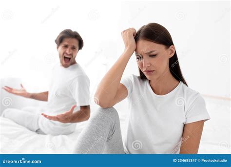 Unhappy Upset Caucasian Millennial Wife Ignores Screaming Husband Lady Sits In Bed In Bedroom