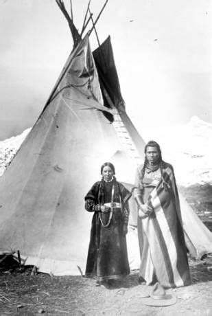 Nez Perce Man And Woman Pose In Front Of Tepee With Mountain Behind