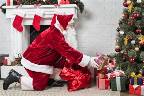 Premium Photo Santa Putting Presents Under Christmas Tree