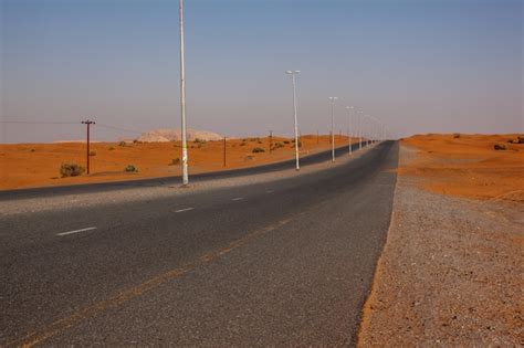 Premium Photo Winding Black Asphalt Road Through Sand Dunes