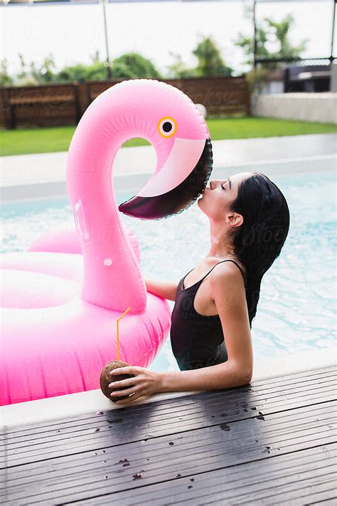 Young Woman In The Pool Kissing Big Flamingo By Stocksy Contributor Jovana Rikalo Stocksy
