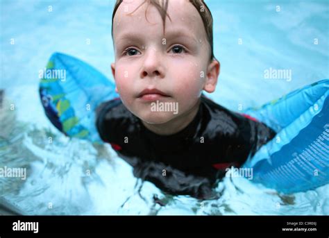 A Child With Water Wings In A Swimming Pool Stock Photo Alamy