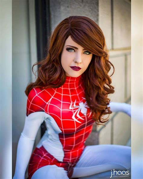 a woman with red hair wearing a spider suit