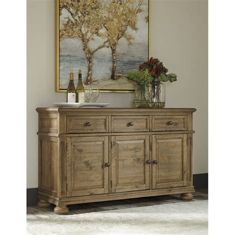 Ashley furniture has some great pieces at reasonable prices. Ashley Trishley Buffet in Light Brown - D659-60