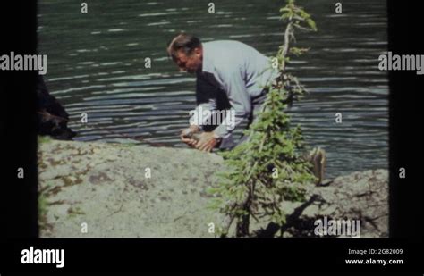HOLLAND LAKE MONTANA USA 1972 Man Catches A Fish With His Bare Hands