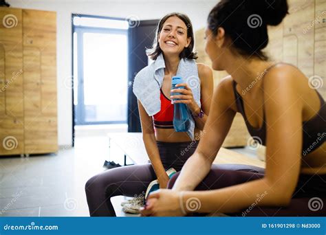 Happy Friends Enjoying Break While Chatting In The Gym Stock Photo Image Of Couple Group
